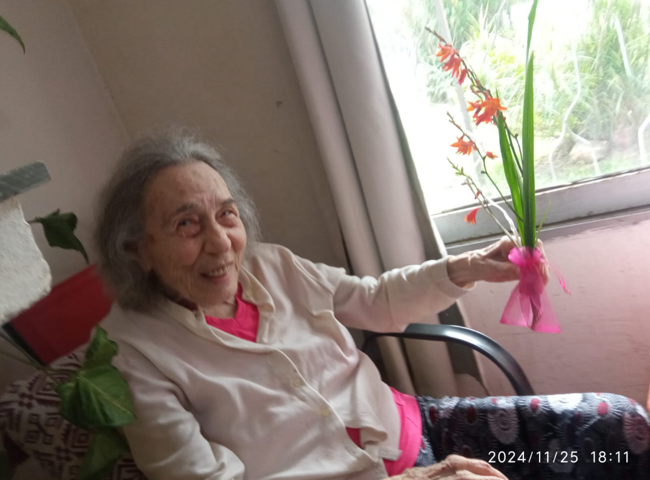 Picture of Loretta holding pink flower